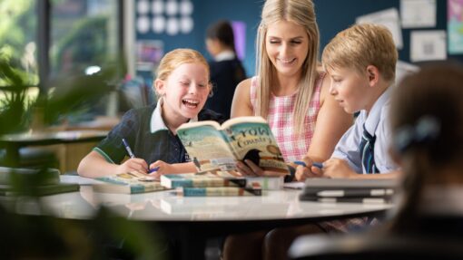 Primary teacher with student reading