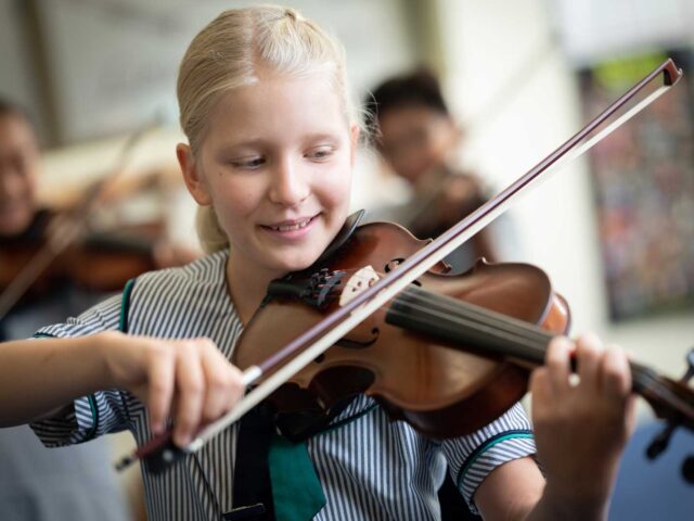 Primary student playing the violin